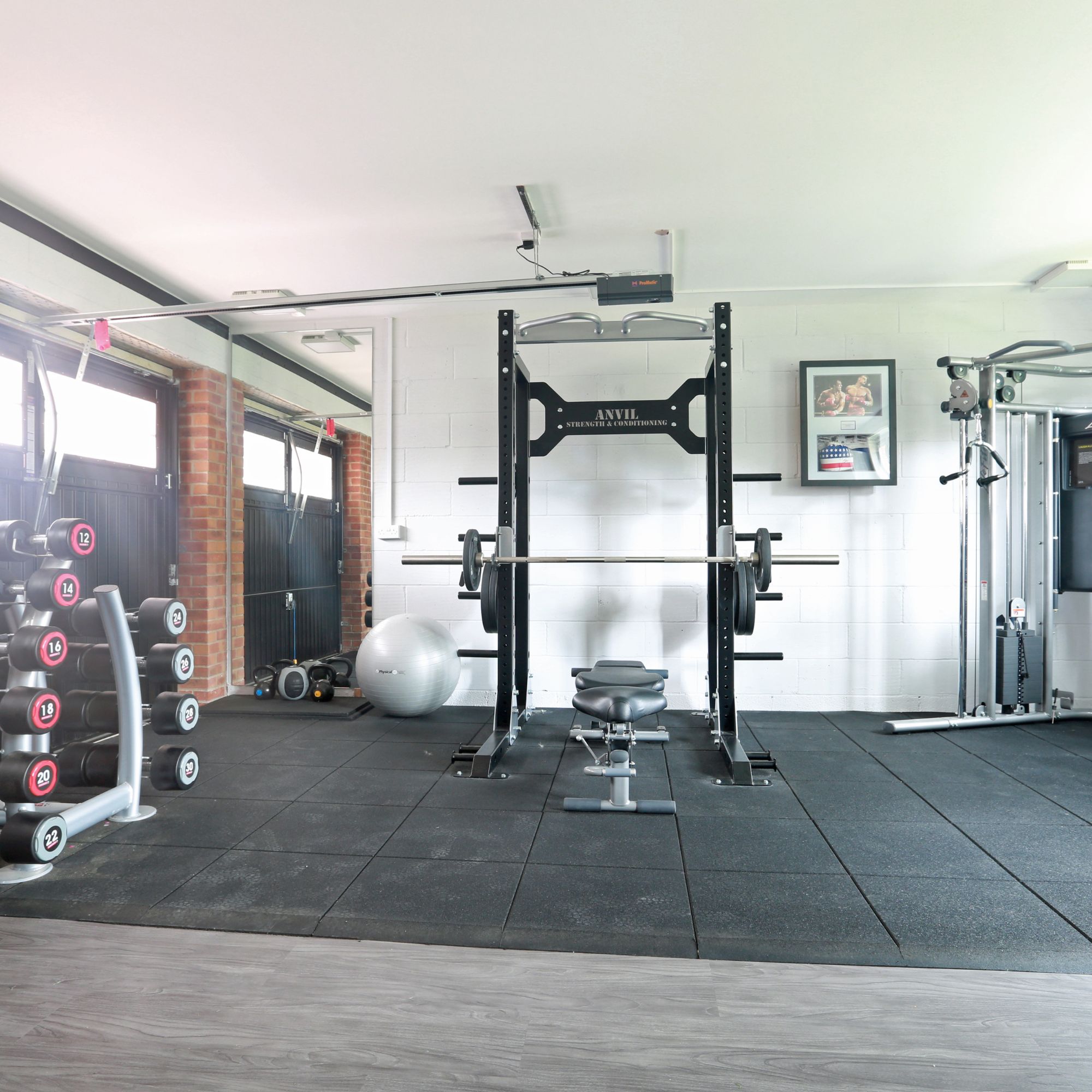 Functional gym layout showcasing distinct zones for cardio, strength, and functional training.