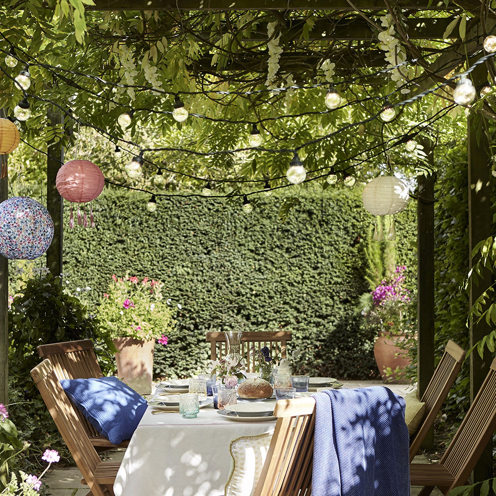 Strategically used colorful cushions, decor, and diverse plants to add color and texture to a patio.