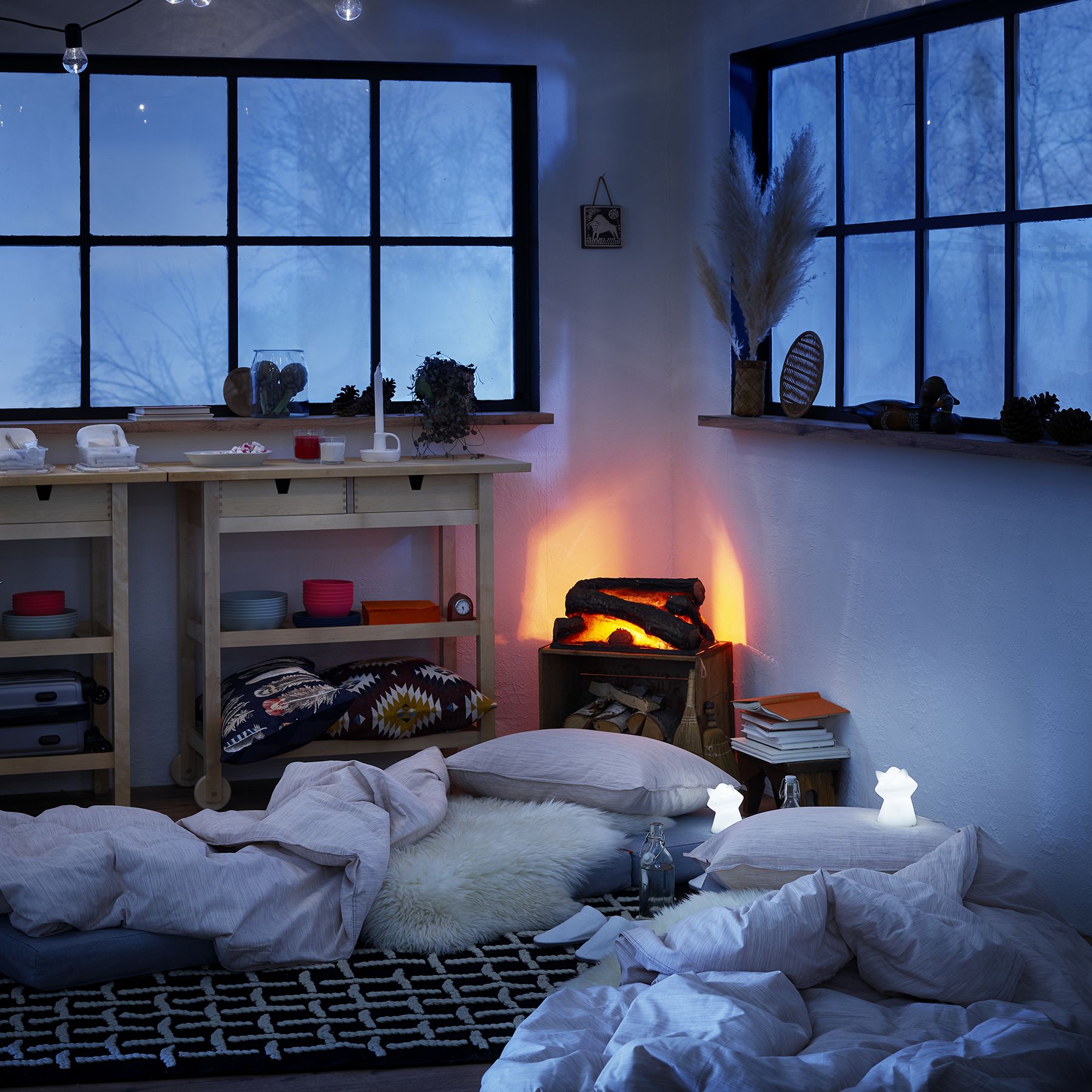 A close-up of bedroom wall art and a book collection, emphasizing personalized decor.