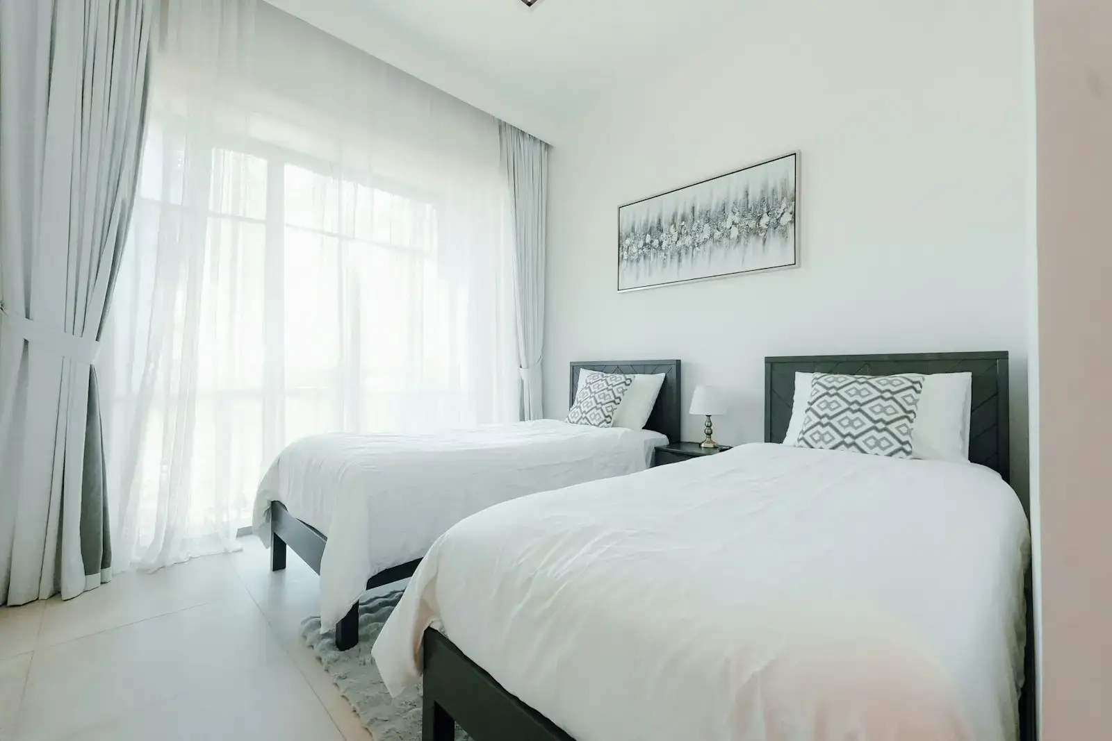 Guest bedroom with smart storage, including drawers and a dedicated space for luggage.